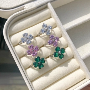 Detailed macro view of S925 silver rings with colorful zircon heart-shaped clover stones