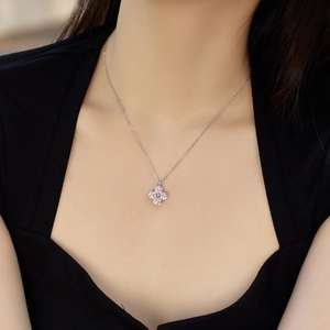 Detail of S925 sterling silver necklace featuring a floral pendant with pink cubic zirconia