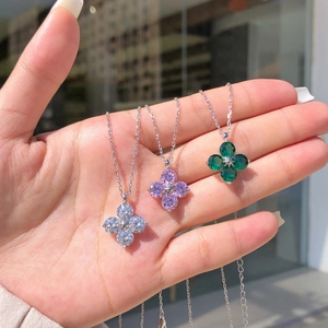 Detailed shot of S925 silver clover necklaces with white, purple and green zircons