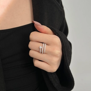 Spiral S925 sterling silver ring with triple wrap zircon pavé design on female hand