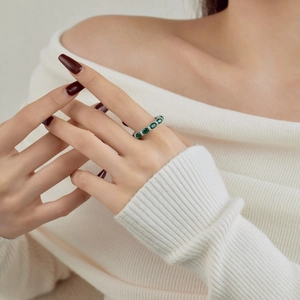 Detailed view of S925 silver ring with oval emerald zircon and pave crystals on hand