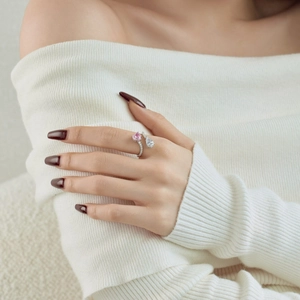 Detail of S925 sterling silver ring featuring a pink heart and clear pear-shaped gemstone