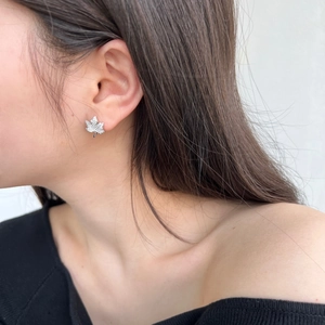 Close-up of S925 sterling silver maple leaf stud earrings with pavé cubic zirconia