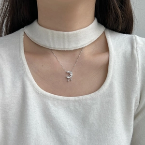 Close-up of S925 sterling silver crescent moon necklace with zircon stones on female model