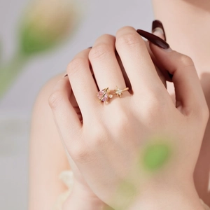 Detail of gold-plated silver ring with pink heart zircon, star shape and small pearl