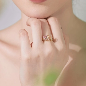 Macro view of adjustable S925 silver ring featuring pink heart stone and pearl star detail