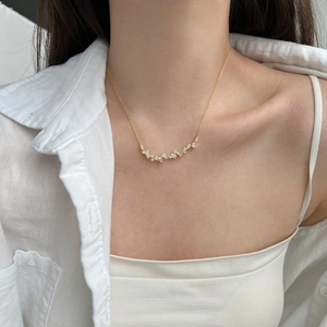 Detailed view of S925 silver necklace with sparkling mixed-cut cubic zirconia on model