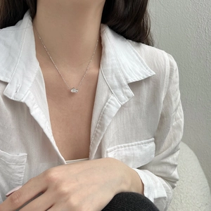 Close-up of minimalist S925 silver necklace with double heart zircon pendant on model