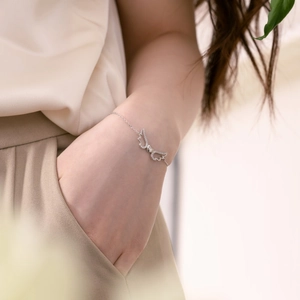 Elegant S925 sterling silver bracelet featuring sparkling zircon angel wings on a wrist