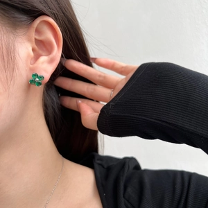 Elegant S925 sterling silver four-leaf clover earrings with green zircon on model