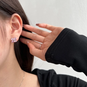 Close-up of S925 sterling silver four-leaf clover stud earrings with pink cubic zirconia