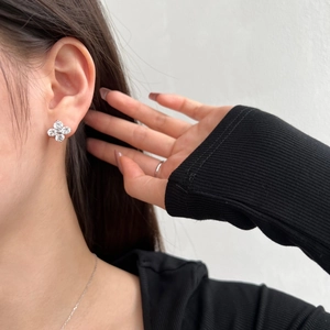 Close-up of S925 sterling silver four-leaf clover earrings with sparkling cubic zirconia