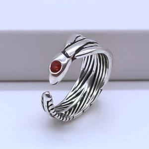 Vintage oxidized silver feather ring with a vibrant red bead accent and open design