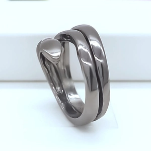 Macro shot of industrial black snake-shaped metal ring with dual wrap-around structure