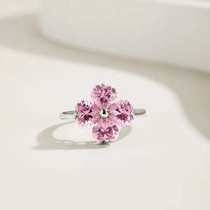 Close-up of S925 silver ring featuring four pink heart-shaped zircons in a clover design