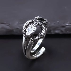 Macro shot of vintage snake ring with textured scales and adjustable open design