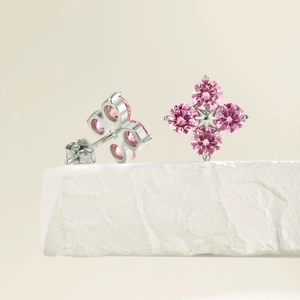Macro view of S925 sterling silver four-leaf clover earrings with pink cubic zirconia