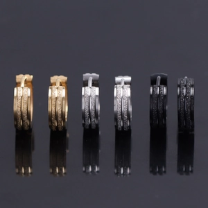 Three pairs of textured hoop earrings in gold silver and black with frosted finish center