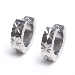 Polished stainless steel huggie earrings featuring intricate star pattern engravings
