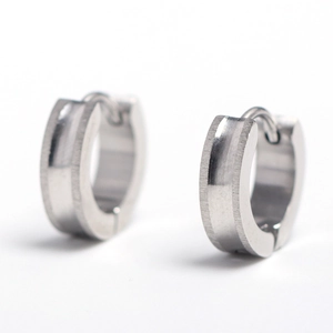 Macro view of silver stainless steel hoop earrings with brushed and mirror finish textures