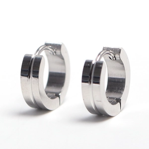 Pair of polished stainless steel hoop earrings with center groove on white background