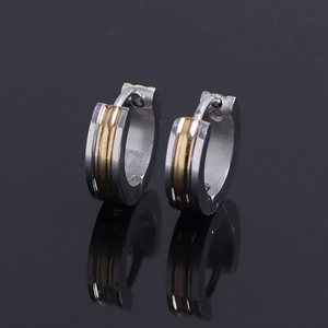 Macro shot of two-tone gold and silver stainless steel hoop earrings with high polish finish