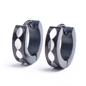 Close-up of 4mm black stainless steel hoop earrings with silver leaf pattern detail