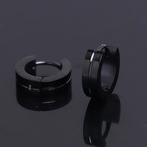 Macro shot of matte black stainless steel hoop earrings with silver grooved center line