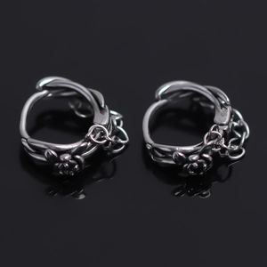 Silver stainless steel hoop earrings with twisted texture and dangling chain accents