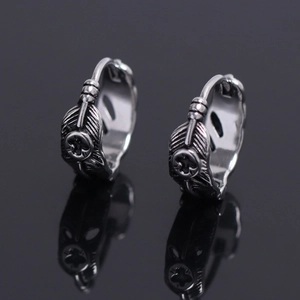 Vintage stainless steel feather hoop earrings with central fleur-de-lis emblem
