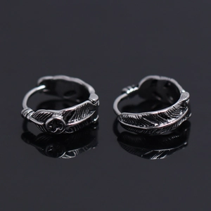 Vintage stainless steel feather hoop earrings with cross pattern on black background