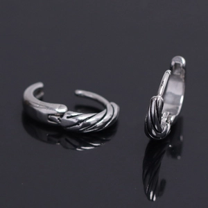 Detail of twisted rope texture and clasp mechanism on stainless steel hoop earrings