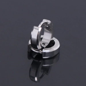 Macro shot of polished silver stainless steel hinged hoop earrings with reflective mirror effect