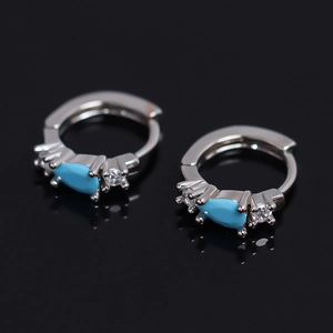 Silver hoop earrings with sky blue teardrop gemstones and small clear diamonds