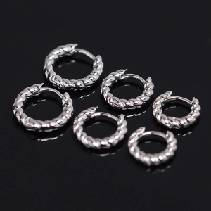 Three pairs of twisted hoop earrings in polished silver metal with braided texture