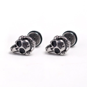 Detailed macro view of punk skull stud earrings with headphone design in vintage steel
