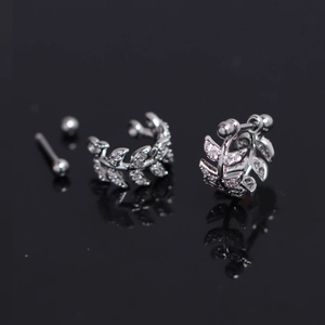 Macro detail of silver leaf earrings with zircon inlay and screw ball back design