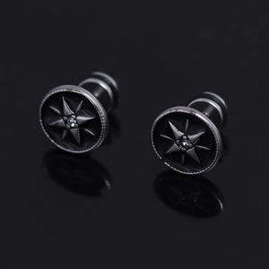 Detail of black stainless steel star ear studs with crystal center and relief design