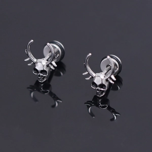 Gothic punk skull stud earrings in vintage silver stainless steel on black background