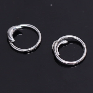 Polished silver stainless steel hoop earrings with crescent moon charms on black background
