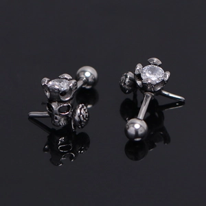 Close-up of gothic skull crown stud earring with clear zircon and screw back ball
