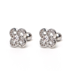 Macro shot of silver clover zircon stud earrings with rotating ball screw back closures