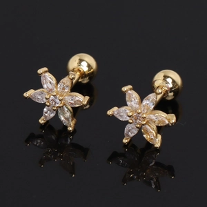 Elegant gold flower stud earrings with marquise cubic zirconia on reflective black background