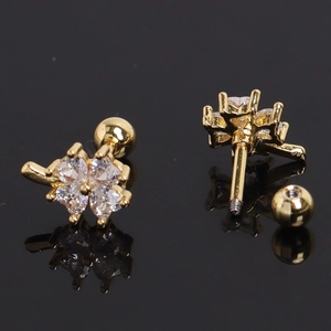 Detailed view of gold clover earrings with heart-shaped crystals and screw back ball design