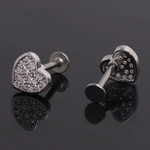 Macro detail of heart stud earring with pavé zircons and flat screw back design