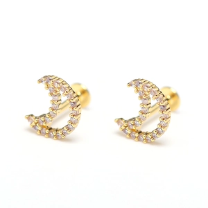 Macro detail of gold crescent moon stud earrings with sparkling zircon pave setting
