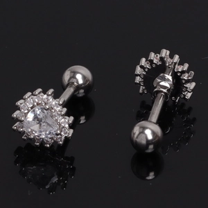 Macro detail of heart-shaped zircon earrings with silver screw ball backings