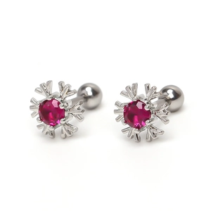 Elegant snowflake earrings with red zircon and secure screw back closure on white background