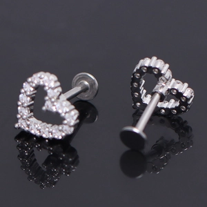 Macro view of heart-shaped stainless steel earrings with white cubic zirconia inlay