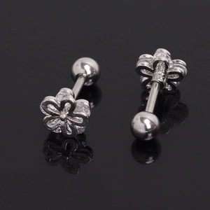 Pair of flower shaped stainless steel stud earrings with clear zircon stones on black background